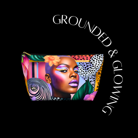 Makeup bag with a colorful design of a woman's face on a black background with 'Grounded & Glowing' text.