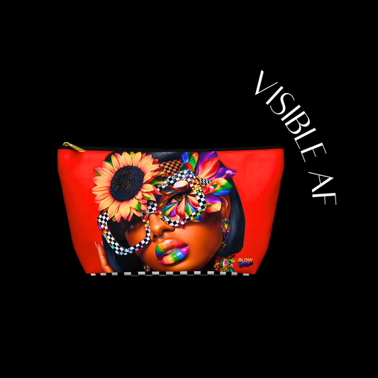 Red pouch with a colorful design of a woman's face and floral headpiece on a black background, featuring the brand 'VISIBLE AF'.